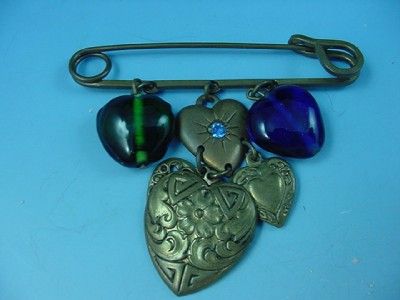 This is a fabulous vintage heart motif charm necklace from Glass Works 